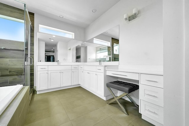 bathroom featuring walk in shower, a healthy amount of sunlight, vanity, and tile patterned flooring