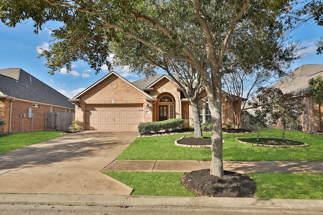 view of front of property with a front yard and a garage