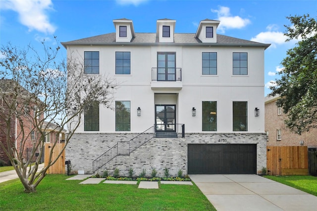 view of front of home with a garage and a front lawn