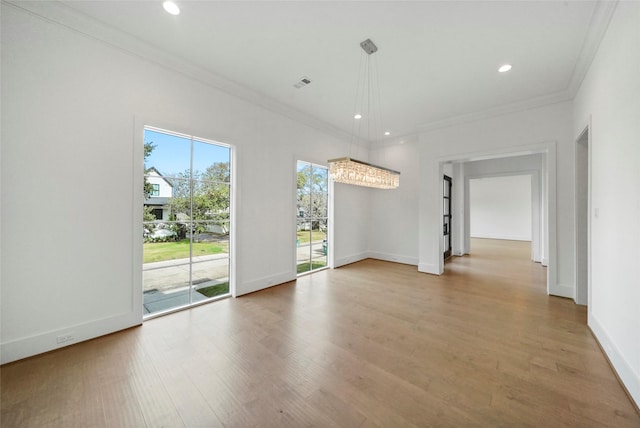 spare room featuring hardwood / wood-style floors and ornamental molding