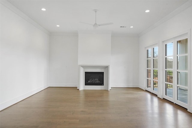 unfurnished living room featuring hardwood / wood-style floors, ceiling fan, and ornamental molding