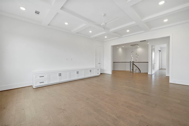 spare room featuring beam ceiling, light hardwood / wood-style floors, ceiling fan, and coffered ceiling