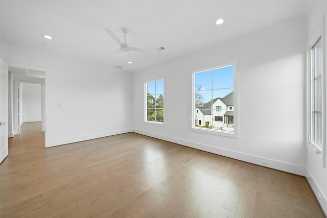 empty room featuring ceiling fan, crown molding, and light hardwood / wood-style flooring