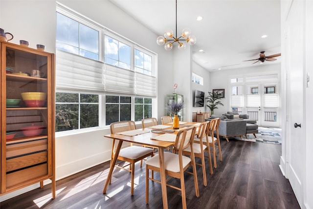 dining room featuring dark hardwood / wood-style floors, a healthy amount of sunlight, and ceiling fan with notable chandelier