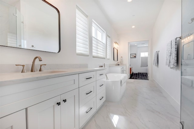 bathroom featuring vanity and a bath