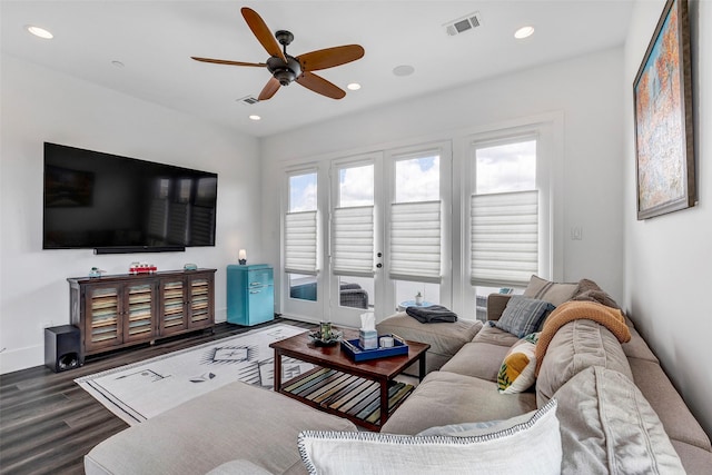 living room with dark hardwood / wood-style floors and ceiling fan