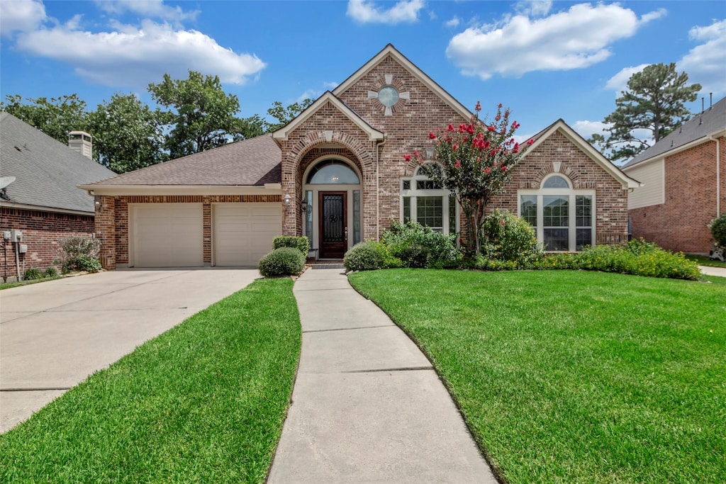 front of property with a garage and a front yard