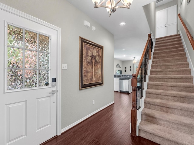 entrance foyer featuring a chandelier and dark hardwood / wood-style flooring