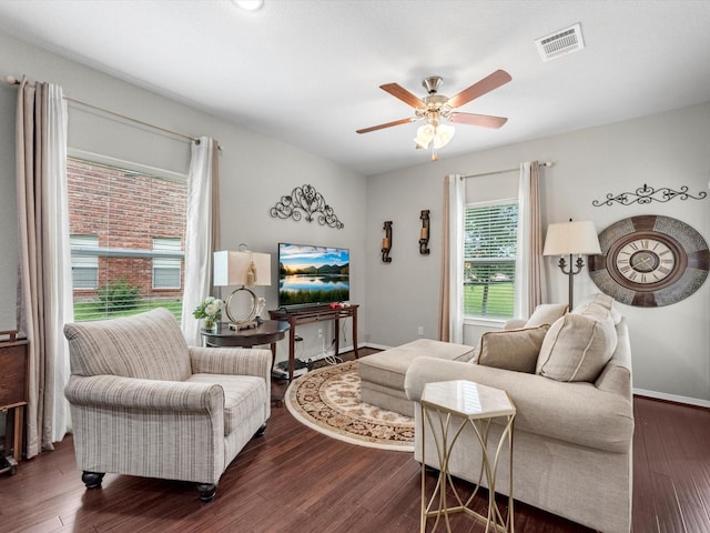 living room featuring dark hardwood / wood-style floors and ceiling fan