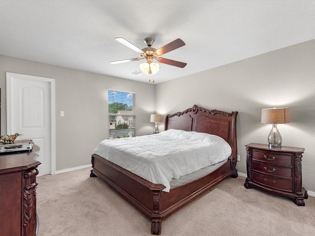 bedroom featuring ceiling fan and light carpet