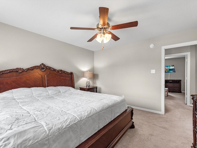 bedroom featuring light carpet and ceiling fan