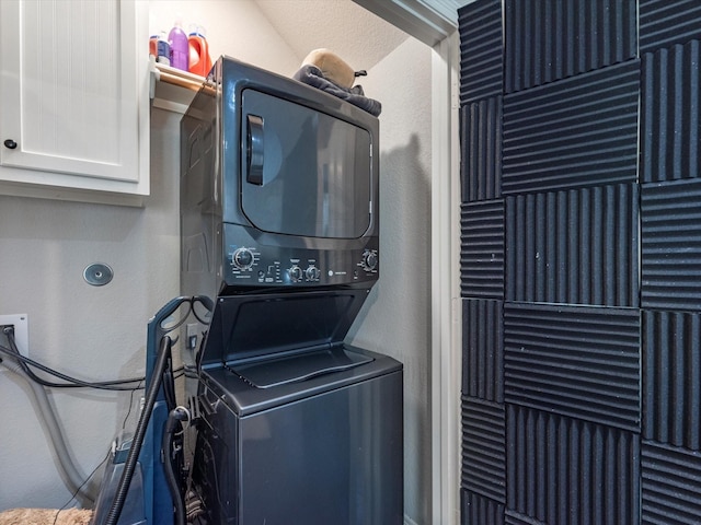 laundry area with stacked washing maching and dryer