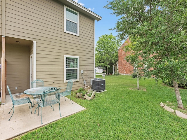 view of yard with a patio area and central air condition unit