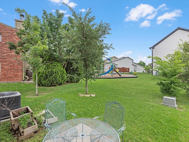 view of yard with a playground and central AC unit