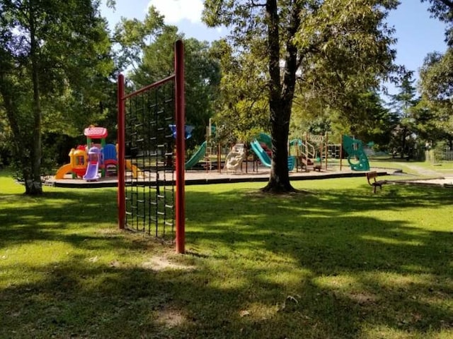 view of playground with a lawn