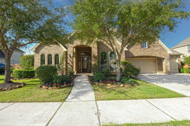 view of front of home with a front lawn and a garage