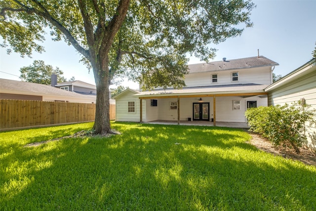 back of house featuring a patio area and a yard