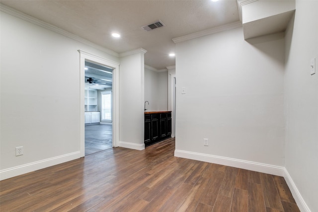 spare room with dark hardwood / wood-style floors and crown molding