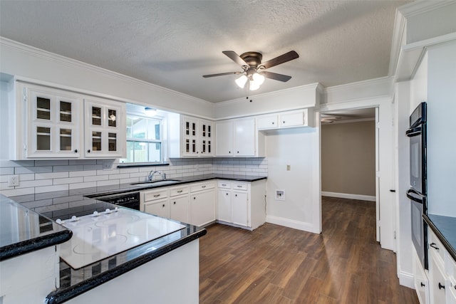 kitchen with black appliances, decorative backsplash, white cabinetry, and a textured ceiling