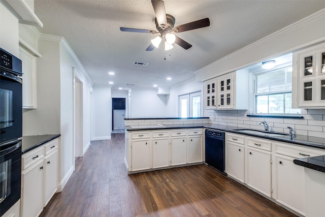 kitchen with white cabinets, sink, kitchen peninsula, and black appliances