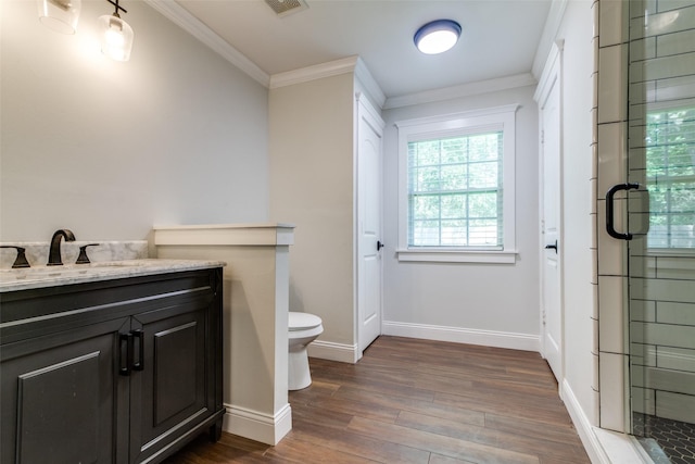 bathroom featuring hardwood / wood-style floors, an enclosed shower, toilet, vanity, and ornamental molding