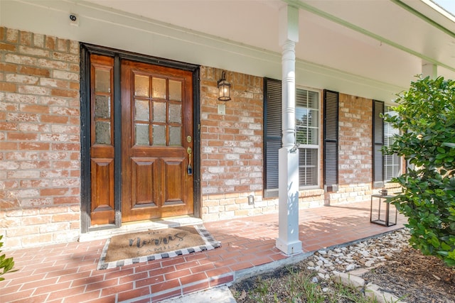 doorway to property featuring covered porch