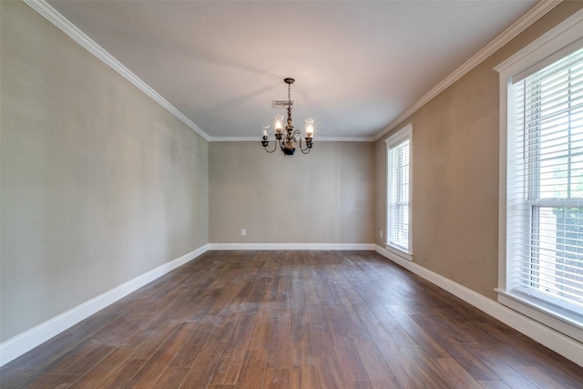 spare room with dark hardwood / wood-style flooring, crown molding, and a chandelier