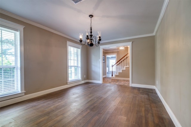 unfurnished dining area with a chandelier, dark hardwood / wood-style floors, and crown molding