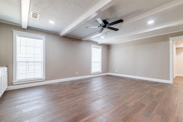 unfurnished room featuring ceiling fan, beam ceiling, dark hardwood / wood-style flooring, and a textured ceiling