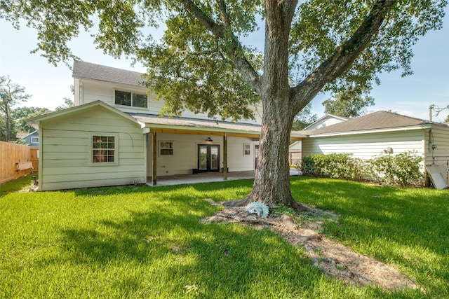 rear view of property with a yard and a patio