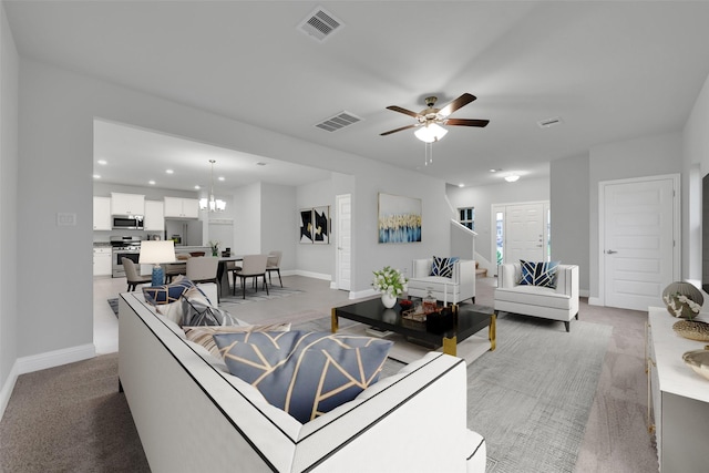 449 Terra Vista Cir, Montgomery, TX 77356 - living area featuring recessed lighting, light colored carpet, ceiling fan, and a chandelier