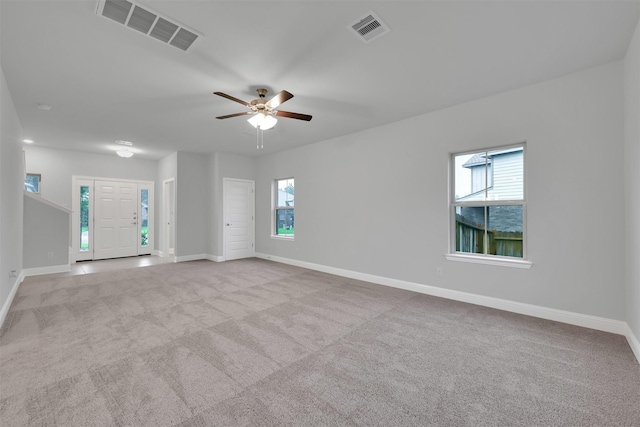 unfurnished room featuring ceiling fan and light colored carpet