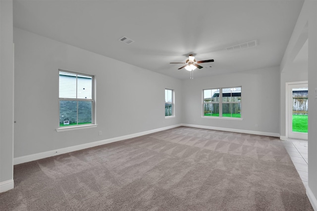 unfurnished room featuring light colored carpet and ceiling fan