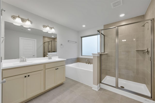 bathroom featuring tile patterned floors, vanity, and independent shower and bath