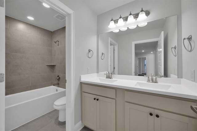 full bathroom with vanity, tile patterned floors, tiled shower / bath combo, and toilet