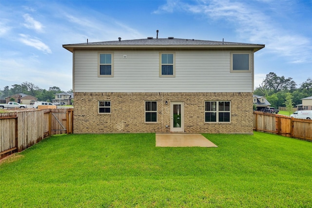 rear view of property featuring a lawn and a patio