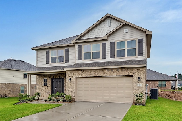 craftsman house featuring cooling unit, a garage, and a front yard