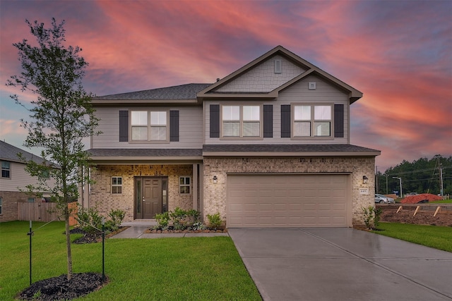 craftsman inspired home featuring a yard and a garage