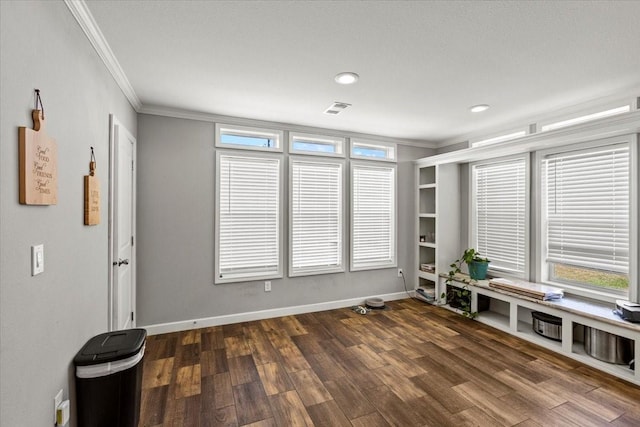 interior space featuring plenty of natural light, crown molding, and dark wood-type flooring