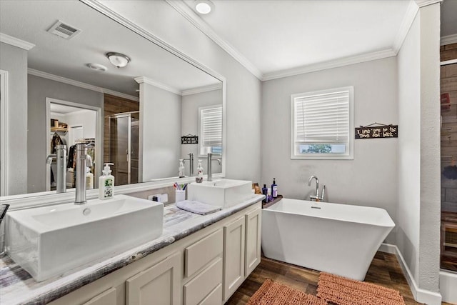 bathroom featuring vanity, hardwood / wood-style floors, plus walk in shower, and ornamental molding