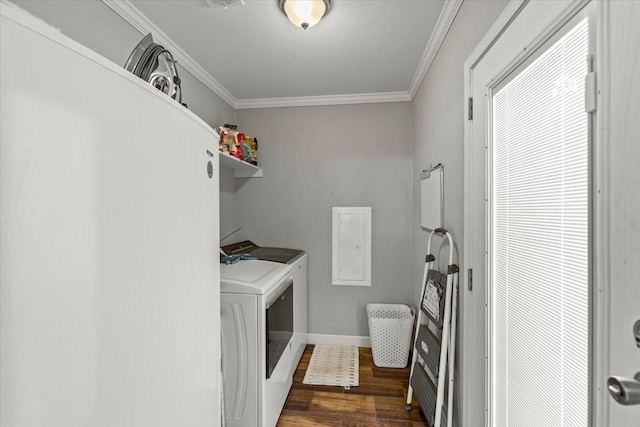 laundry room featuring washer and dryer, ornamental molding, electric panel, and dark wood-type flooring