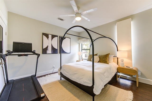 bedroom with ceiling fan and dark hardwood / wood-style flooring