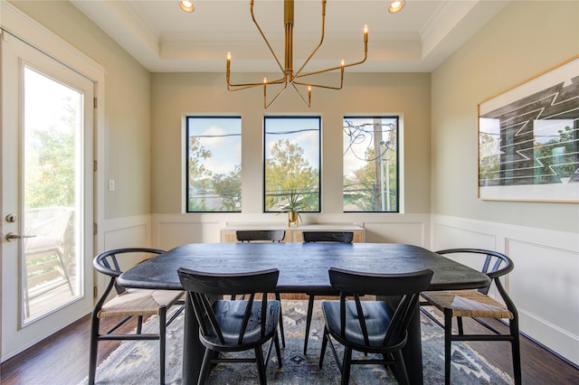 dining area featuring a tray ceiling, dark hardwood / wood-style floors, and crown molding