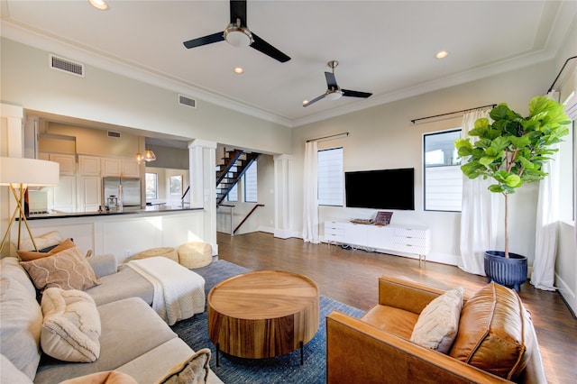 living room featuring ceiling fan, dark wood-type flooring, and crown molding