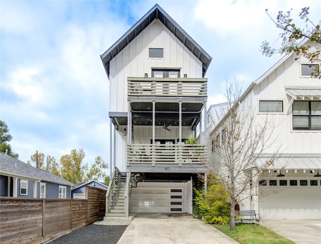 modern inspired farmhouse with a balcony, a garage, and ceiling fan