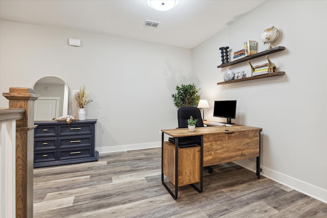 office with light hardwood / wood-style flooring