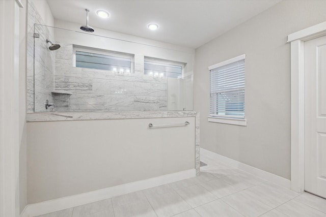 bathroom featuring tile patterned floors and a tile shower