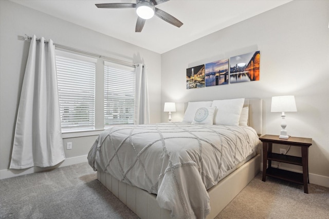 bedroom with ceiling fan and light carpet