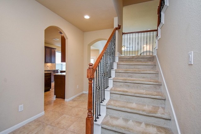 stairway featuring tile patterned floors