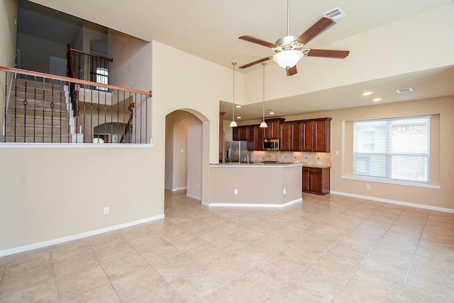 unfurnished living room with ceiling fan